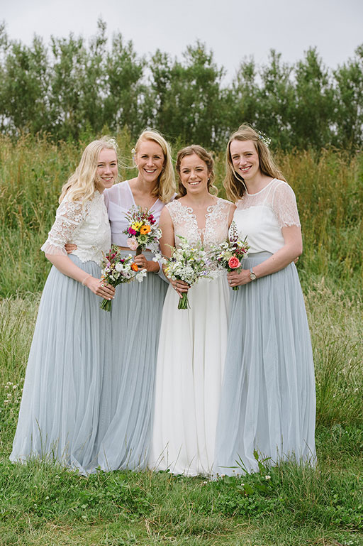 Bride and Bridesmaids in white and blush blue dresses on wedding day