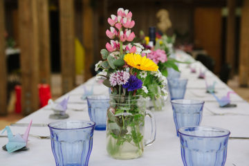Wedding feast tablescape with vintage blue glasses and cottage garden Cornish flowers