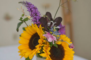 Yellow sunflowers and purple flowers in vintage vase wedding