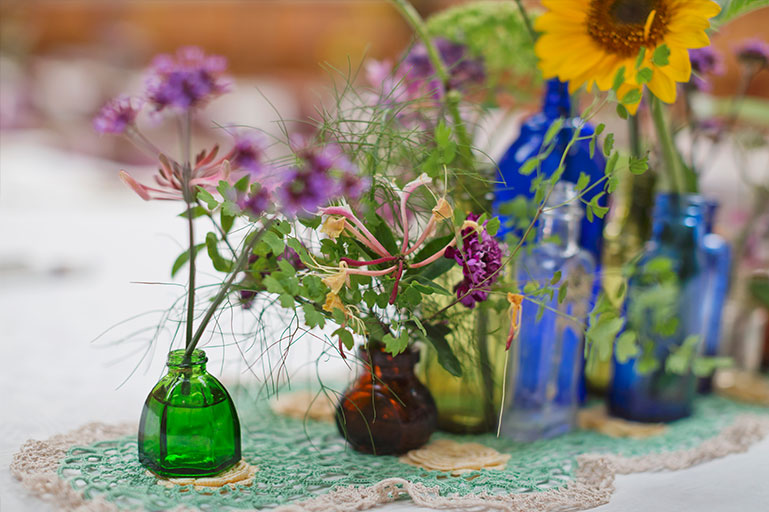 Vintage glass bottles as vases for garden flowers wedding decoration