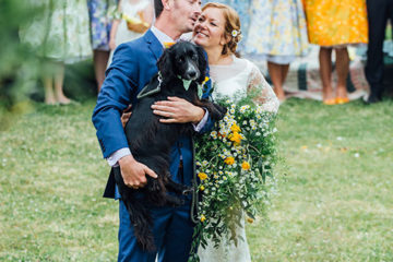 Bride and groom with dog on wedding day