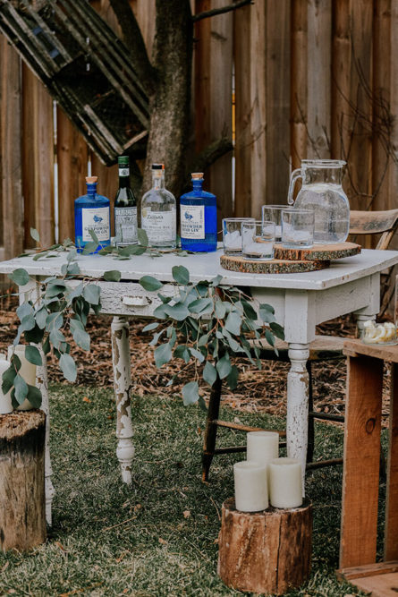 vintage gin bottles on wedding table